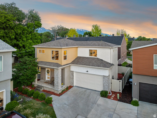4595 College Ridge Court Millcreek, UT 84117 - Photo 49 of 57 Contemporary residence featuring a two-car garage, stone veneer accents, and a covered porch