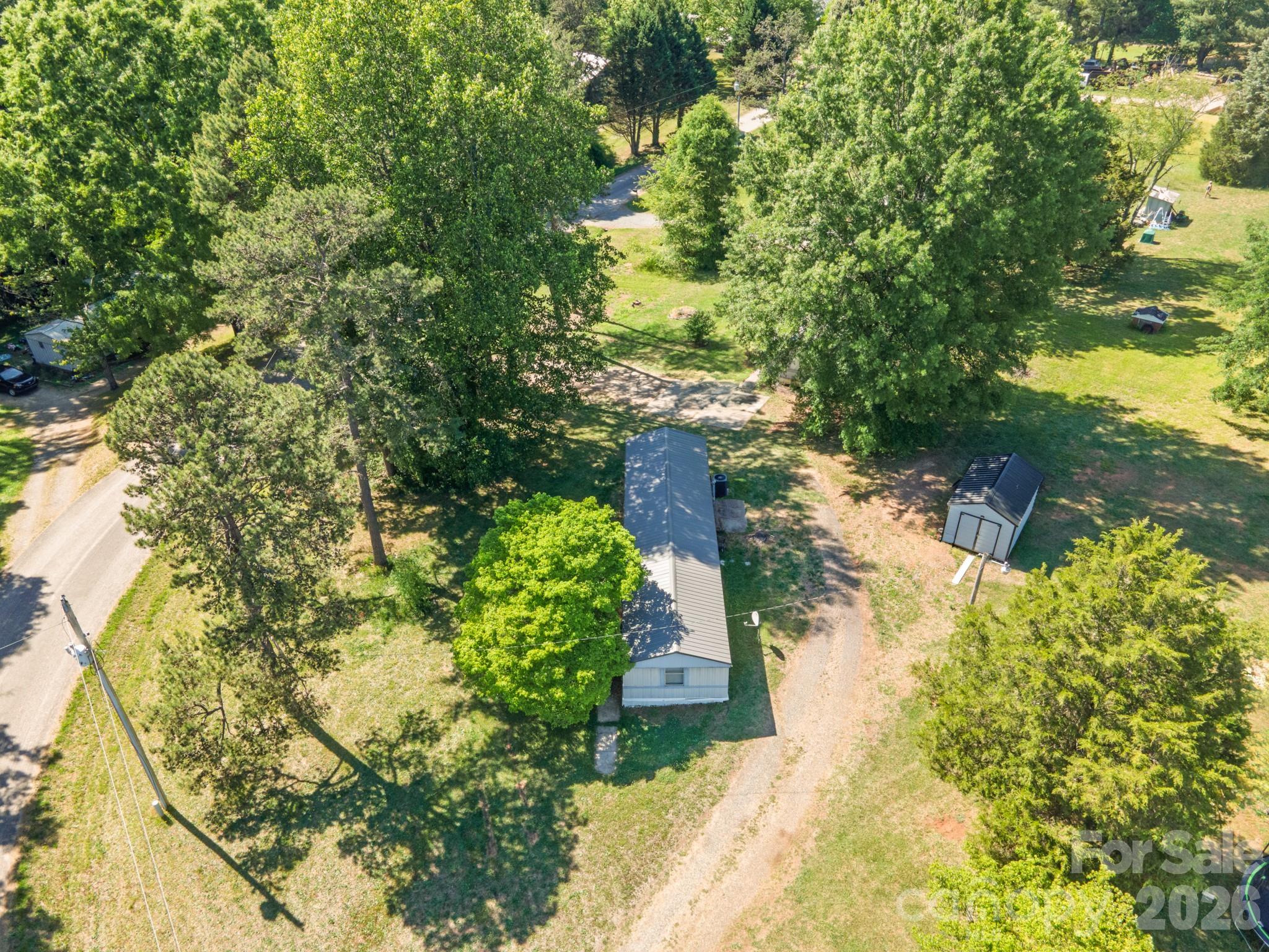 142 Delaware Road Statesville, NC 28625 - Photo 4 of 9 a view of a yard with plants and large trees