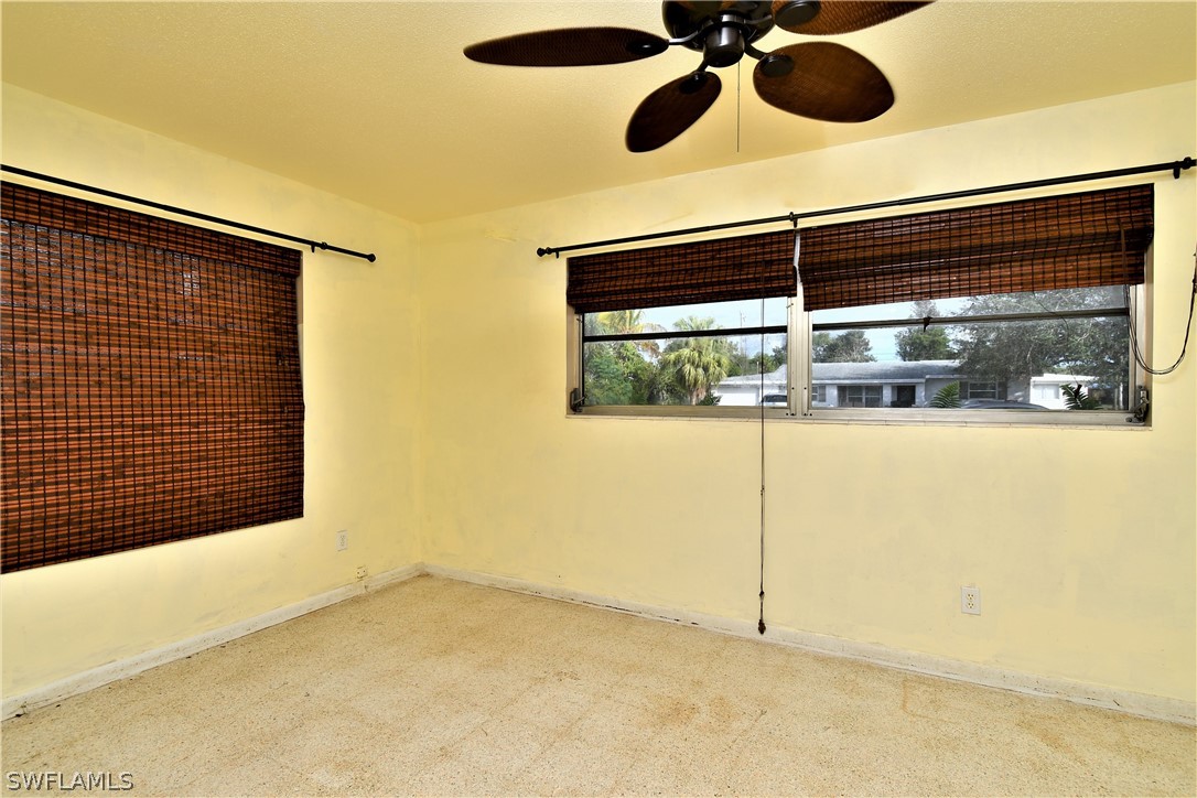 502 Wyoming Road Lehigh Acres, FL 33936 - Photo 11 of 20 a view of a room with a window and a ceiling fan
