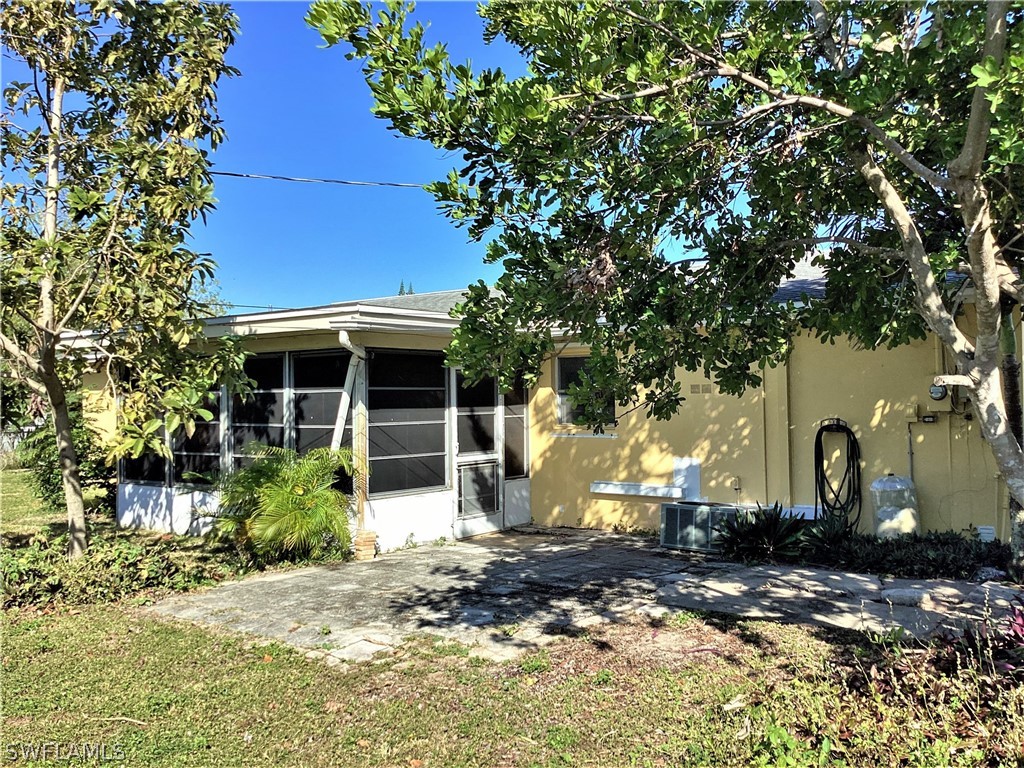 502 Wyoming Road Lehigh Acres, FL 33936 - Photo 19 of 20 a view of a house with a yard