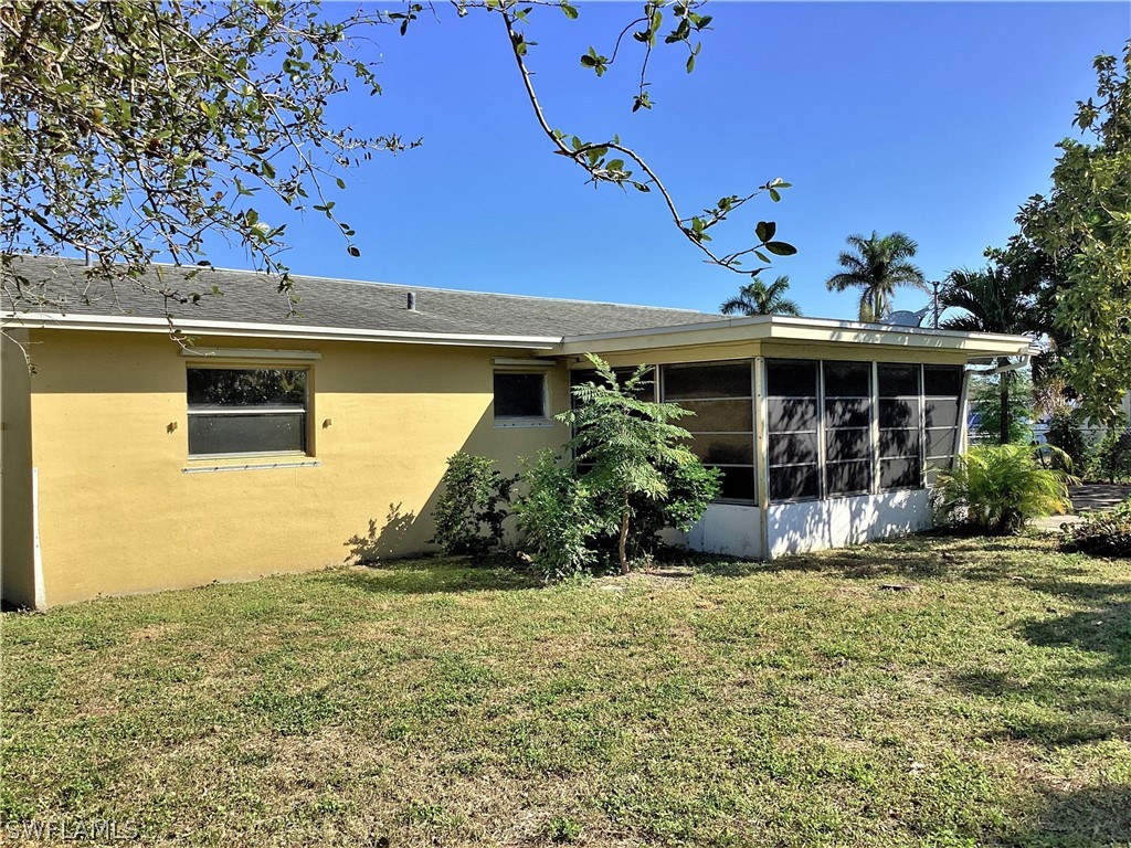 502 Wyoming Road Lehigh Acres, FL 33936 - Photo 20 of 20 a front view of a house with a yard