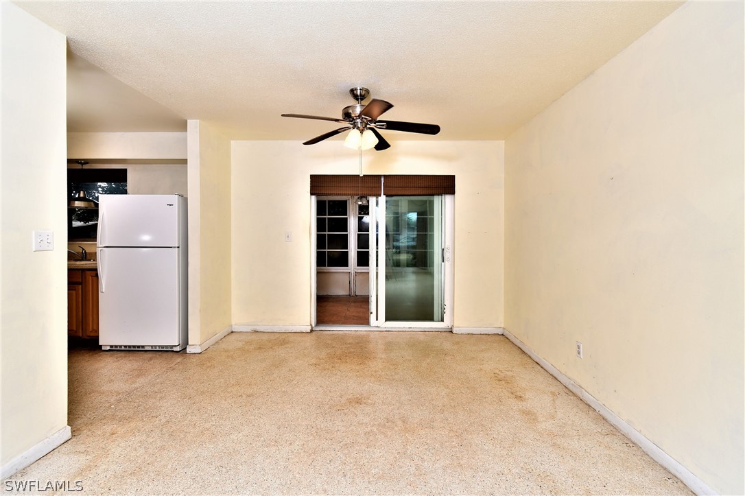 502 Wyoming Road Lehigh Acres, FL 33936 - Photo 5 of 20 a view of a kitchen with a sink and refrigerator