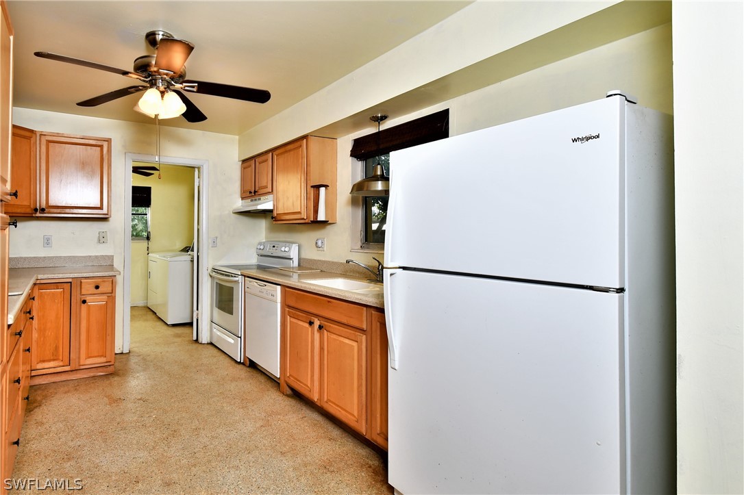 502 Wyoming Road Lehigh Acres, FL 33936 - Photo 6 of 20 a white refrigerator freezer and a stove