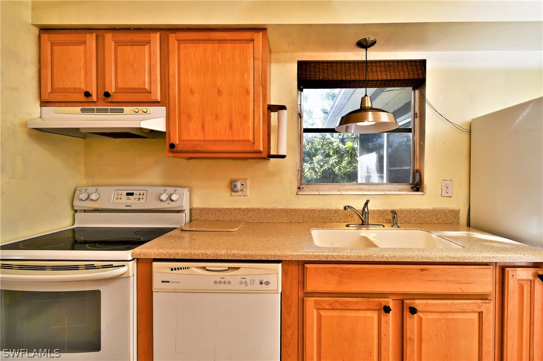 502 Wyoming Road Lehigh Acres, FL 33936 - Photo 8 of 20 a bathroom with a sink and a window
