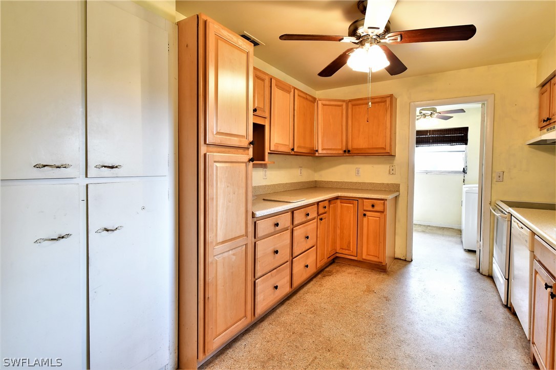 502 Wyoming Road Lehigh Acres, FL 33936 - Photo 9 of 20 a view of a kitchen with electric appliances