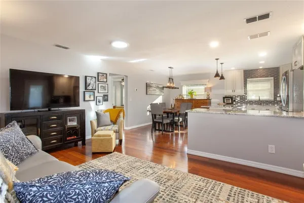 a living room with furniture and kitchen view