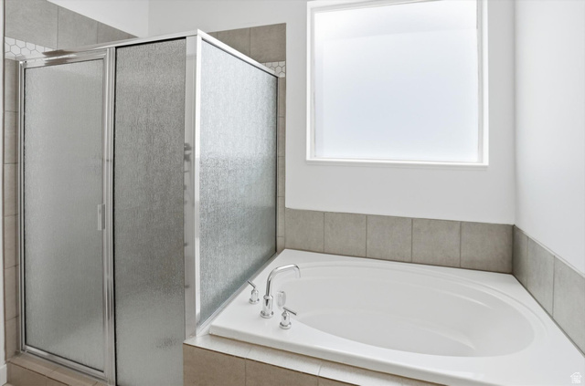 3636 West 910 South Syracuse, UT 84075 - Photo 10 of 70 Built-in soaking tub with chrome fixtures, surrounded by neutral-toned tile