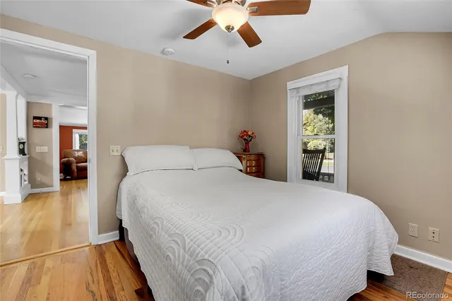 a bedroom with a bed and a ceiling fan