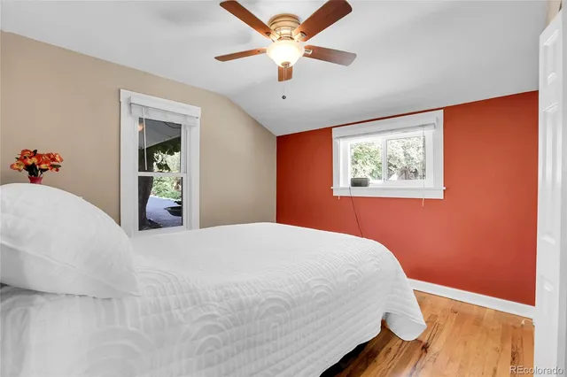 a bedroom with bed and a chandelier