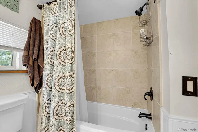 a bathroom with a bathtub and shower