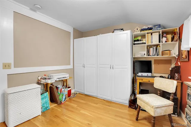 a bedroom with a bed and a chair in it