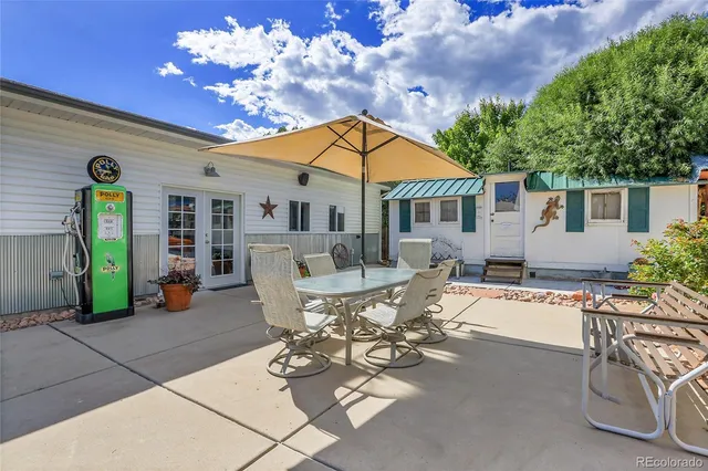 a view of a house with patio and a yard