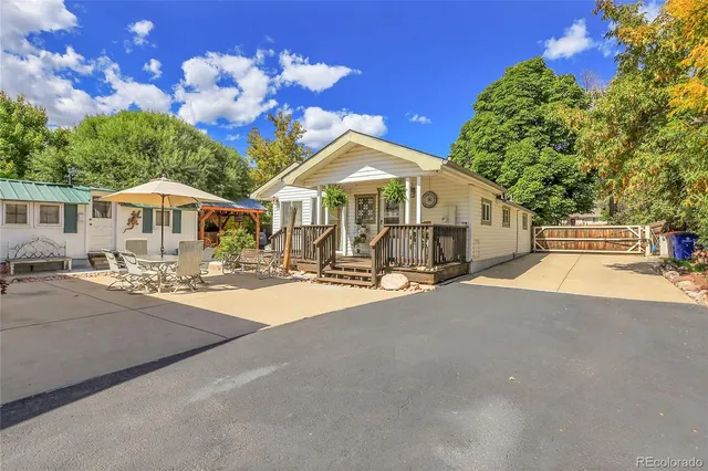 a front view of a house with a yard and a garden