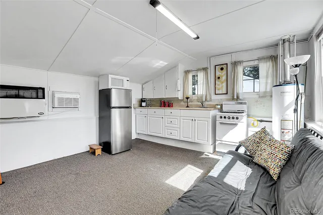 a kitchen with stainless steel appliances a refrigerator sink and cabinets
