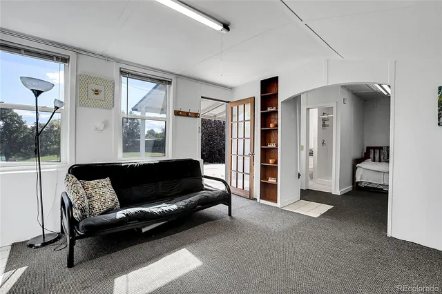 a living room with furniture and a en suite bathroom