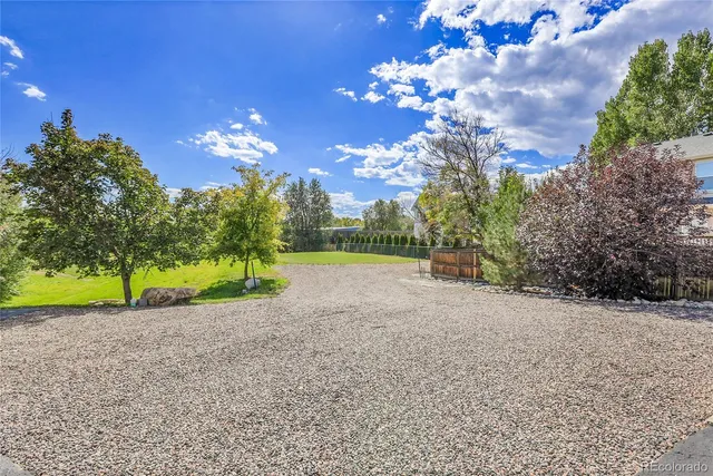 a view of yard with swimming pool and green space