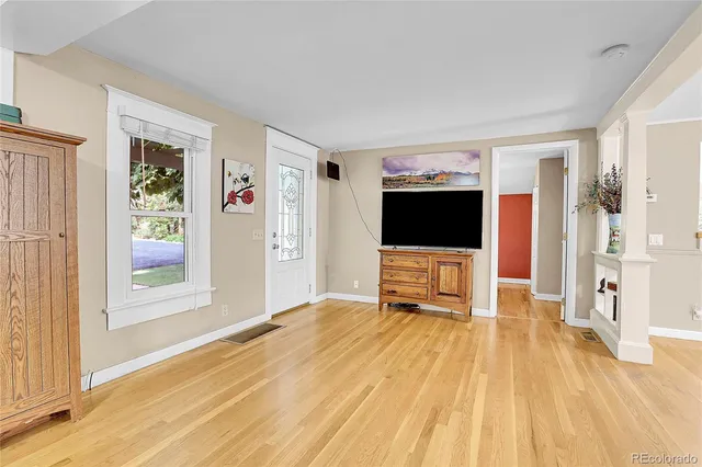 a living room with a flat screen tv and a floor to ceiling window