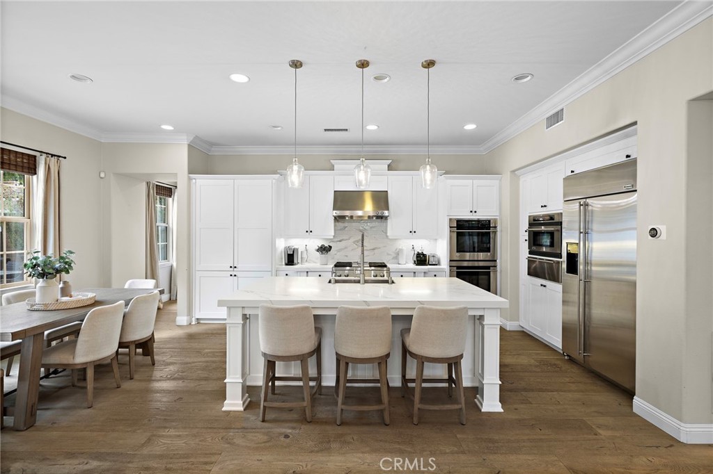 7 Julia Street Ladera Ranch, CA 92694 - Photo 15 of 52 a large kitchen with a table and chairs