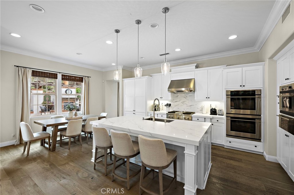 7 Julia Street Ladera Ranch, CA 92694 - Photo 16 of 52 a large kitchen with a table chairs and flat screen tv