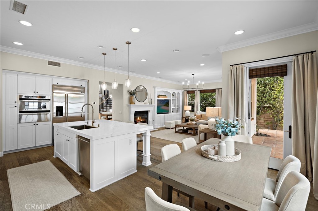 7 Julia Street Ladera Ranch, CA 92694 - Photo 19 of 52 a kitchen with stainless steel appliances wooden floor dining table and chairs