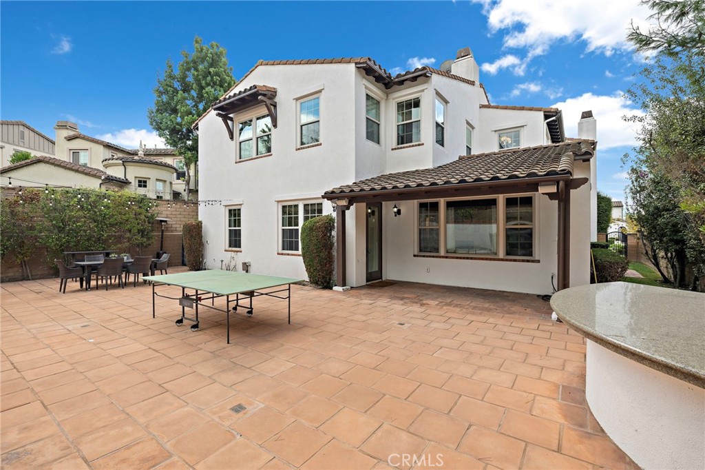 7 Julia Street Ladera Ranch, CA 92694 - Photo 30 of 52 a view of a white house with a chairs and table in patio
