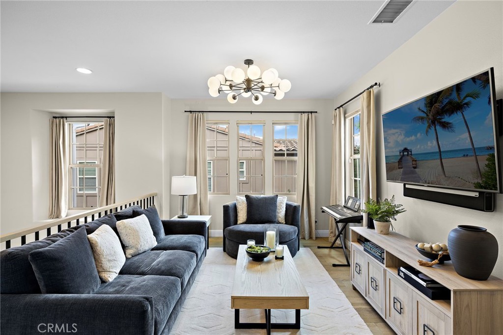 7 Julia Street Ladera Ranch, CA 92694 - Photo 35 of 52 a living room with furniture and a chandelier
