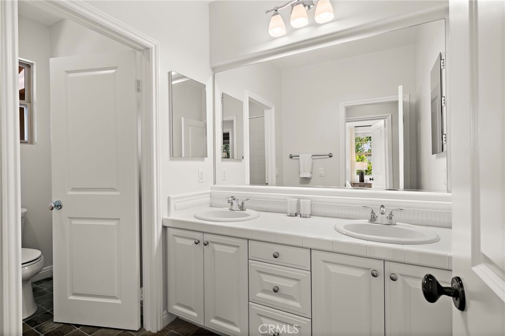 7 Julia Street Ladera Ranch, CA 92694 - Photo 40 of 52 a bathroom with double sink and a mirror