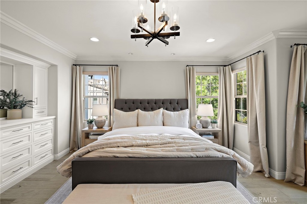 7 Julia Street Ladera Ranch, CA 92694 - Photo 41 of 52 a bedroom with a large bed and a chandelier fan