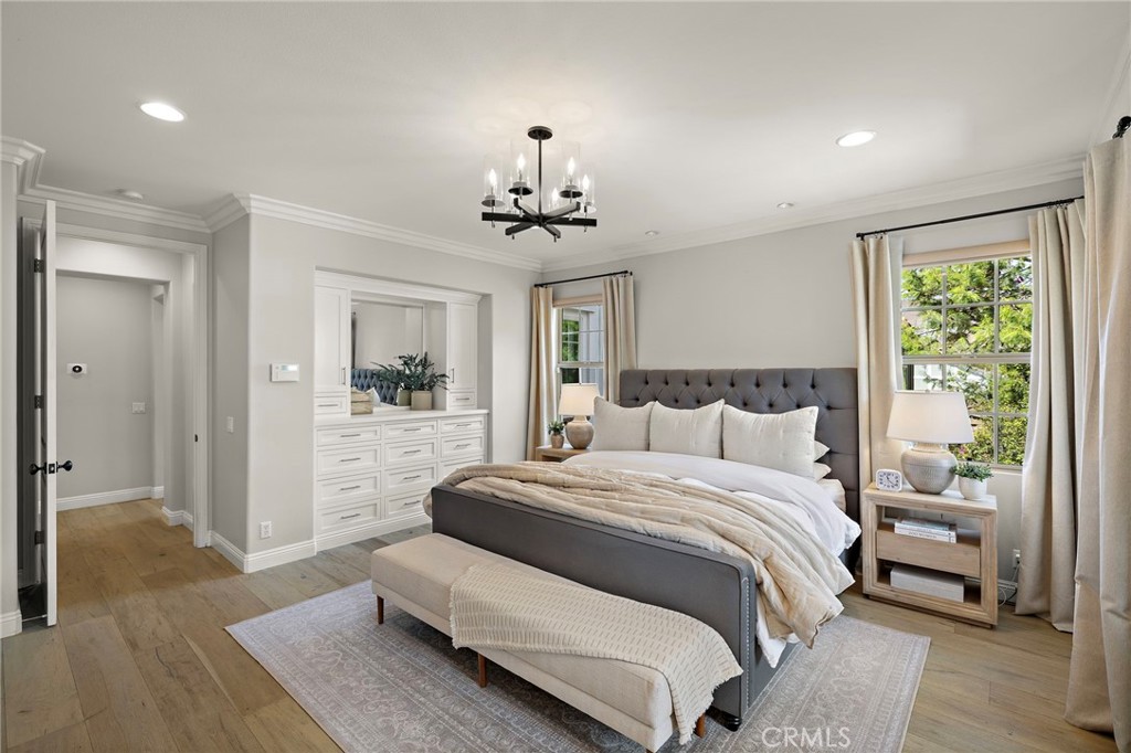 7 Julia Street Ladera Ranch, CA 92694 - Photo 42 of 52 a spacious bedroom with a large bed chandelier and a window