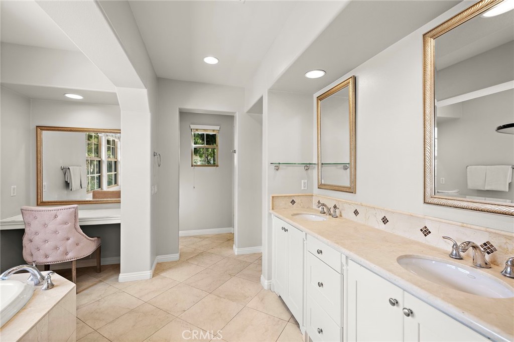 7 Julia Street Ladera Ranch, CA 92694 - Photo 44 of 52 a spacious bathroom with a double vanity sink and a mirror