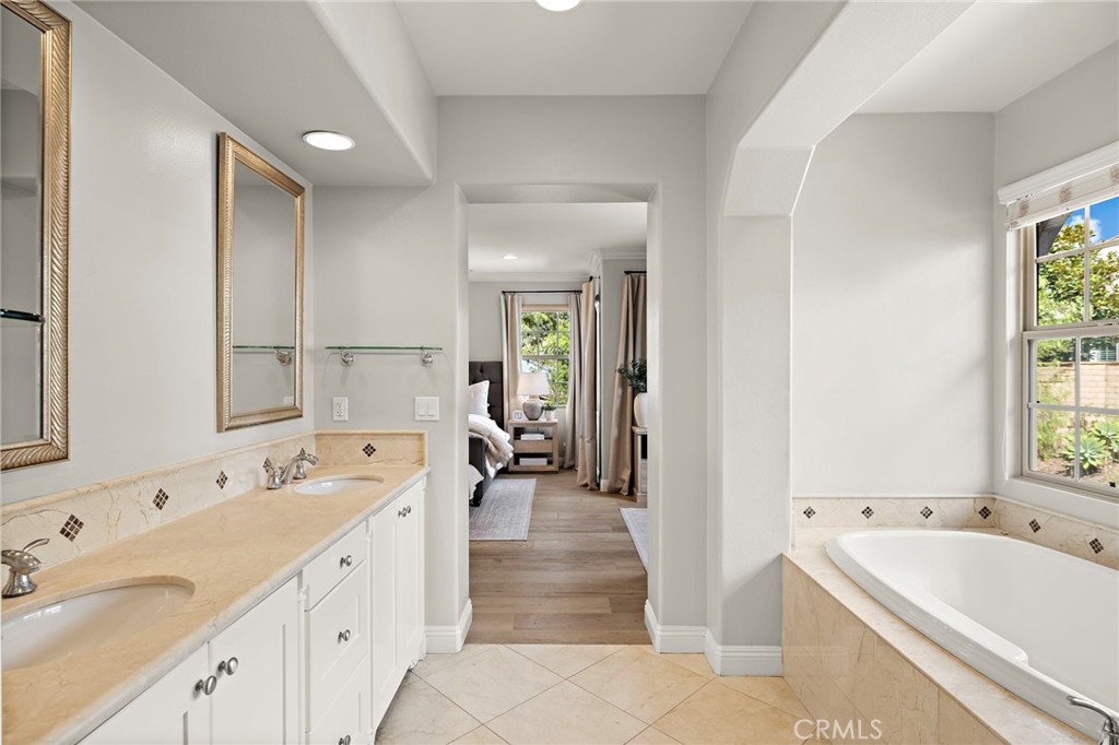 7 Julia Street Ladera Ranch, CA 92694 - Photo 45 of 52 a spacious bathroom with a tub double sink and mirror