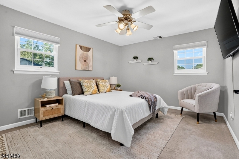 151 East Prospect Street Clark, NJ 07066 - Photo 16 of 31 a spacious bedroom with a bed and a chair