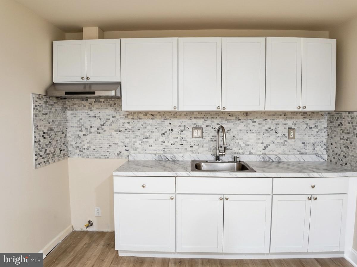 3614 Fawn Spring Court Baltimore, MD 21234 - Photo 18 of 22 a kitchen with granite countertop white cabinets and white appliances