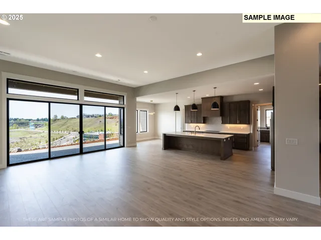 a view of a living room and kitchen with furniture wooden floor and windows