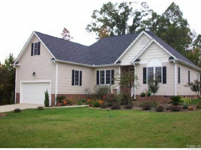 3631 Range Road Stem, NC 27581 - Photo 1 of 1 a front view of a house with a garden and yard