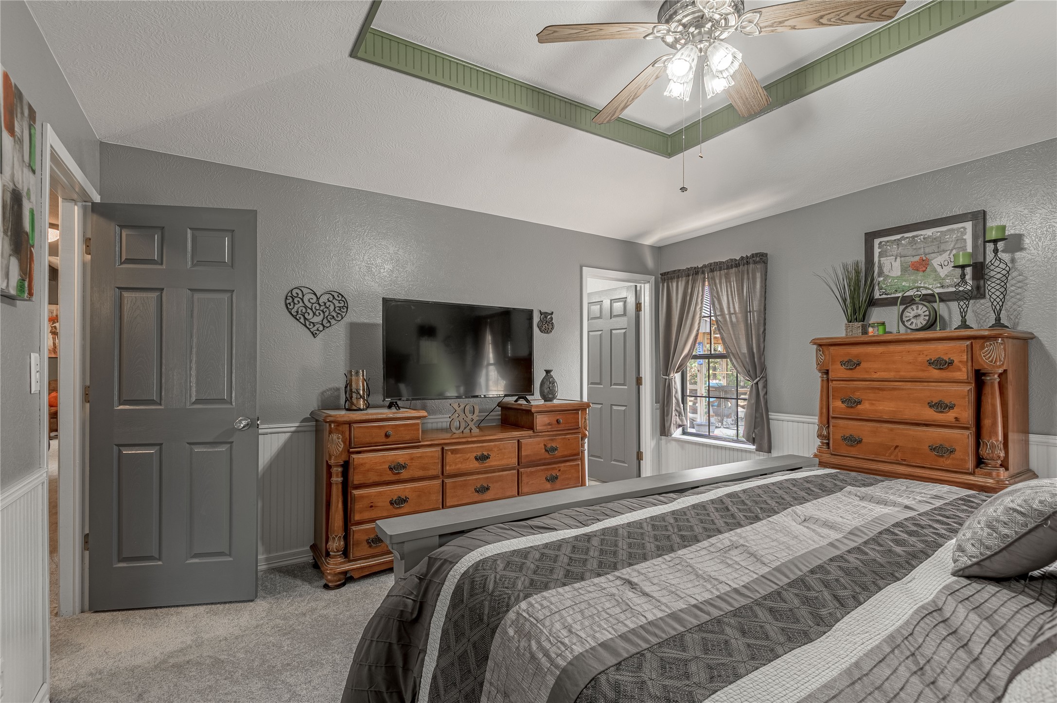 70 William Thomas Road Huntsville, TX 77320 - Photo 19 of 50 a bedroom with a bed and a chandelier