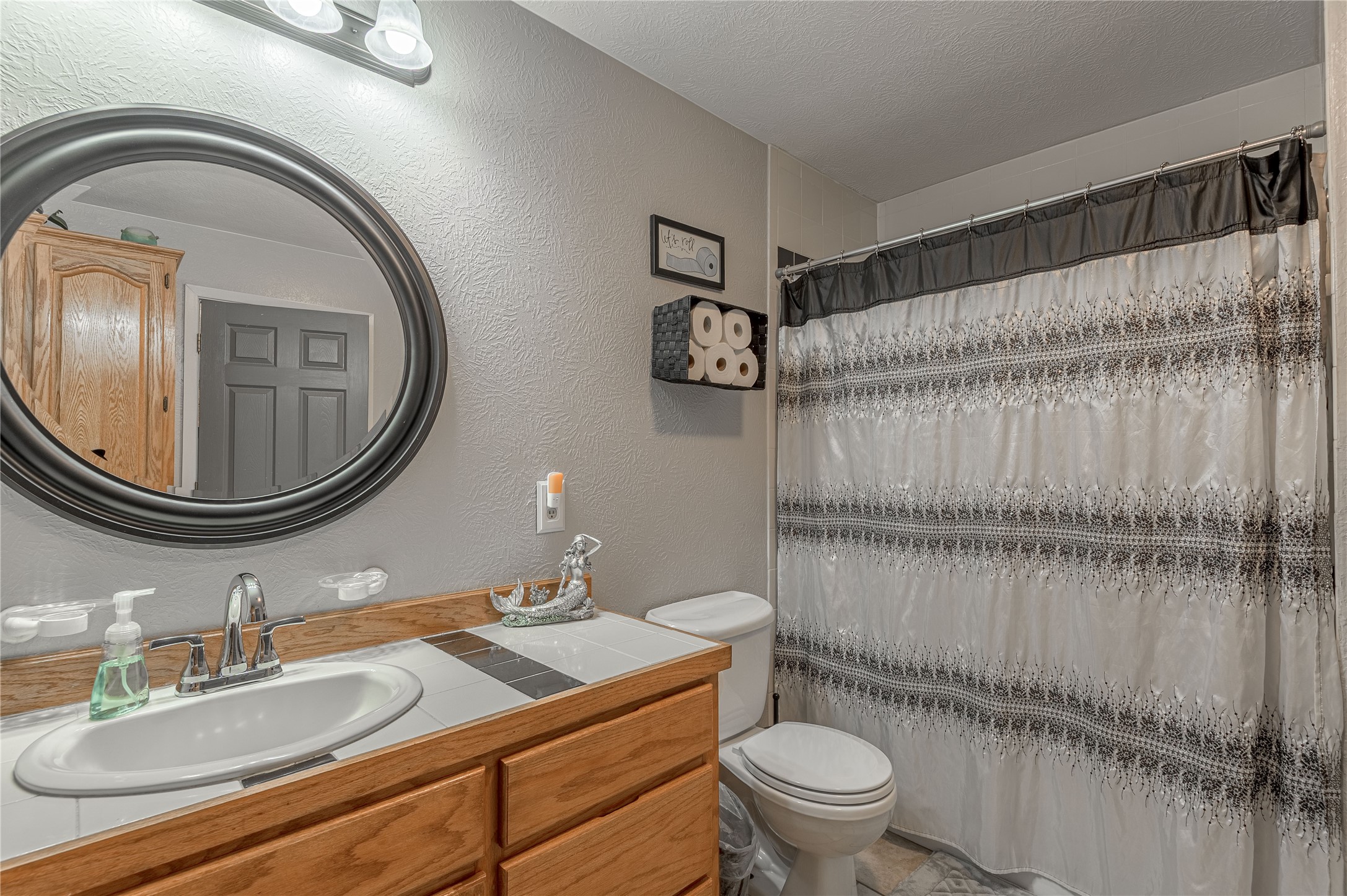 70 William Thomas Road Huntsville, TX 77320 - Photo 25 of 50 a bathroom with a sink a toilet and a mirror