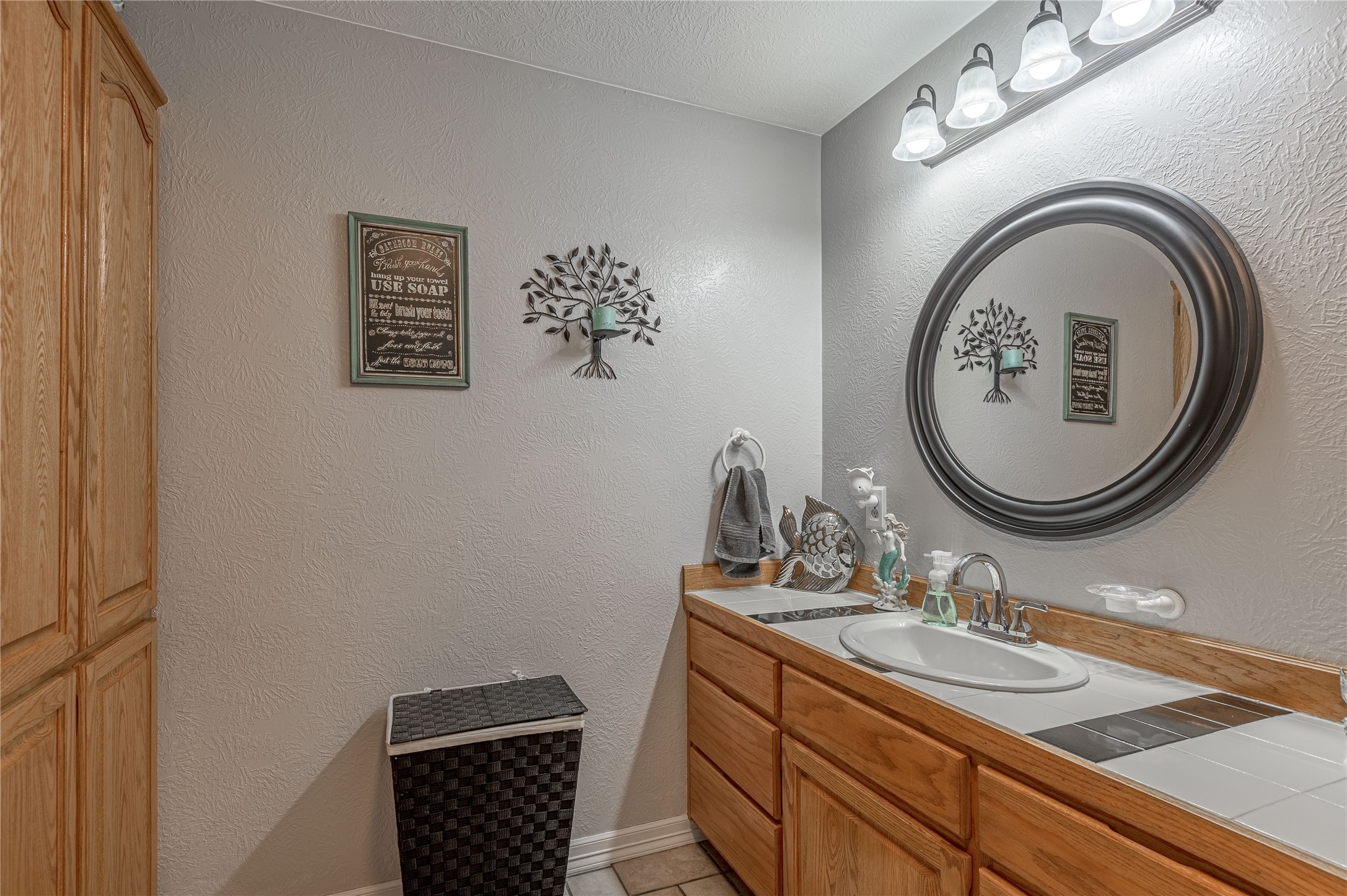 70 William Thomas Road Huntsville, TX 77320 - Photo 26 of 50 a bathroom with a granite countertop toilet a sink and a mirror