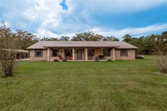 a view of field with trees in background