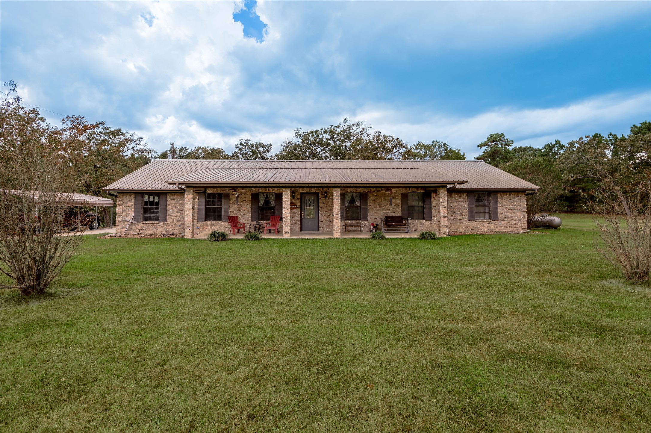 70 William Thomas Road Huntsville, TX 77320 - Photo 29 of 50 a front view of a house with a garden