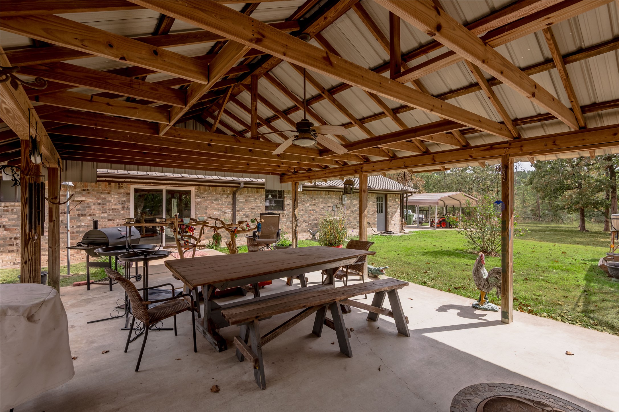 70 William Thomas Road Huntsville, TX 77320 - Photo 41 of 50 a view of a patio with table and chairs and garden view