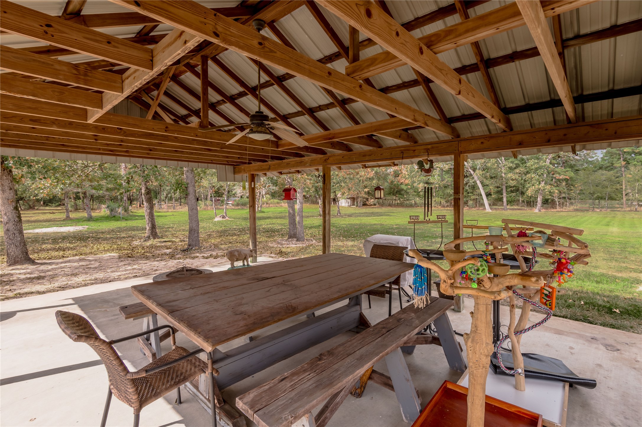 70 William Thomas Road Huntsville, TX 77320 - Photo 42 of 50 a view of a patio with table and chairs and wooden floor
