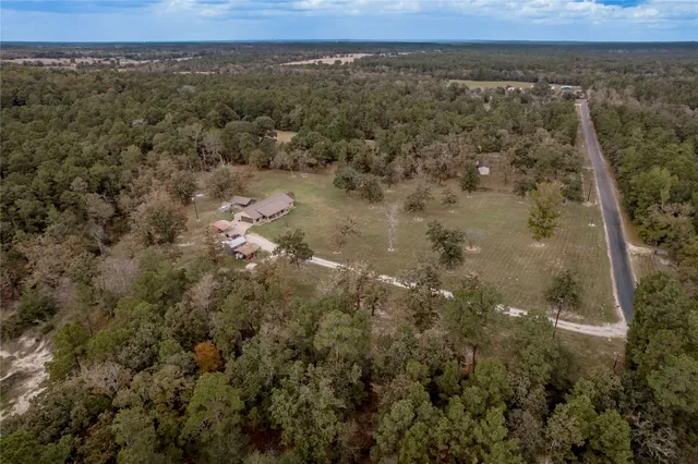 an aerial view of house with yard