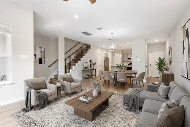 a living room with furniture kitchen view and a table