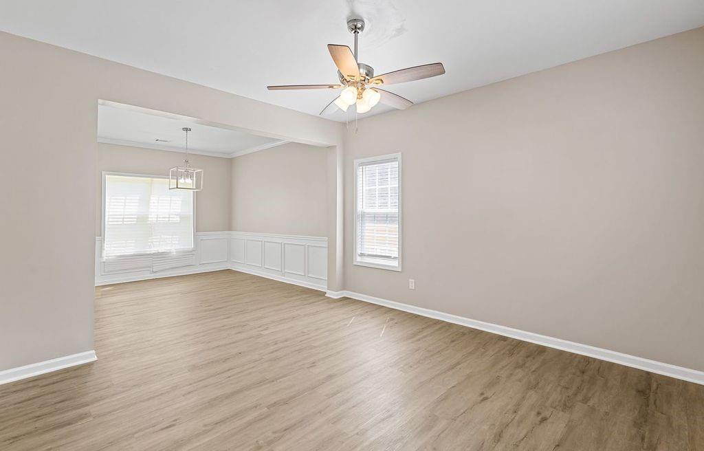 473 Greyhawk Way Fairburn, GA 30213 - Photo 3 of 34 an empty room with wooden floor fan and windows