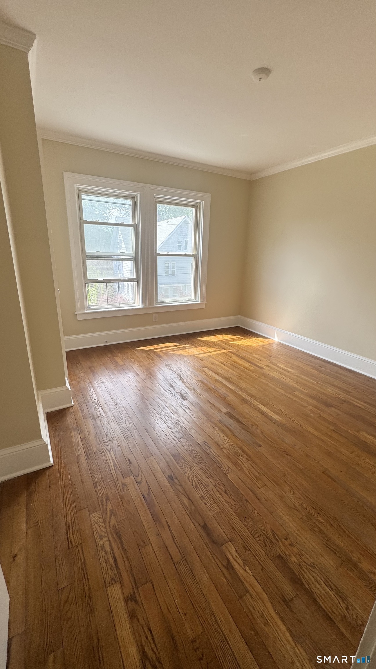 104 Prospect Street Ansonia, CT 06401 - Photo 25 of 40 a view of an empty room with wooden floor and a window