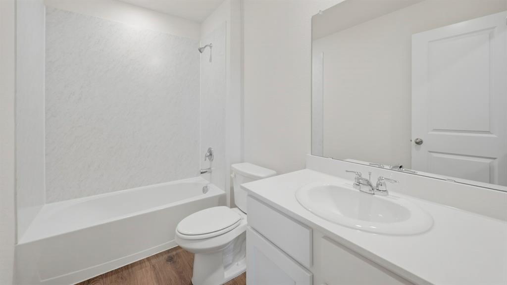 4101 Oakcrest Lane Princeton, TX 75407 - Photo 1 of 26 a bathroom with a sink toilet and a bathtub