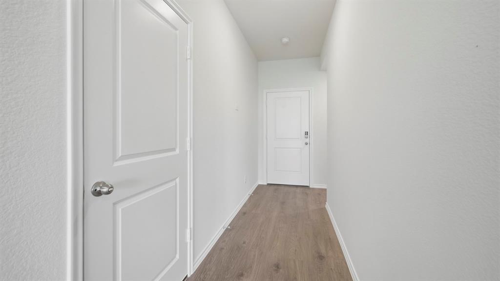 4101 Oakcrest Lane Princeton, TX 75407 - Photo 15 of 26 a view of a hallway with wooden floor