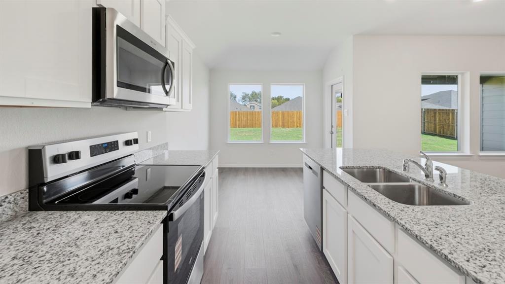 4101 Oakcrest Lane Princeton, TX 75407 - Photo 18 of 26 a kitchen with a stove and a sink
