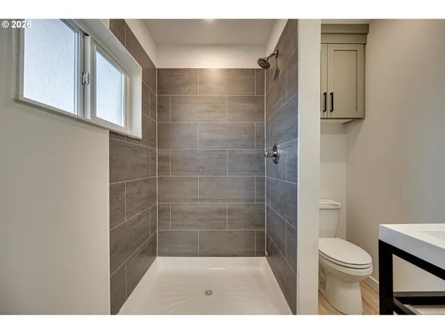 a bathroom with a shower and a toilet